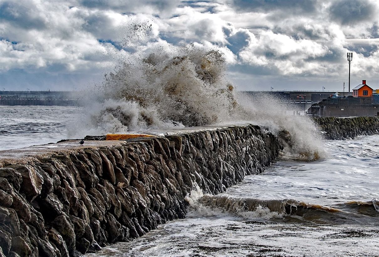 Golven beuken tegen de havenmuur. Foto: ANP / EPA / Stuart Brock