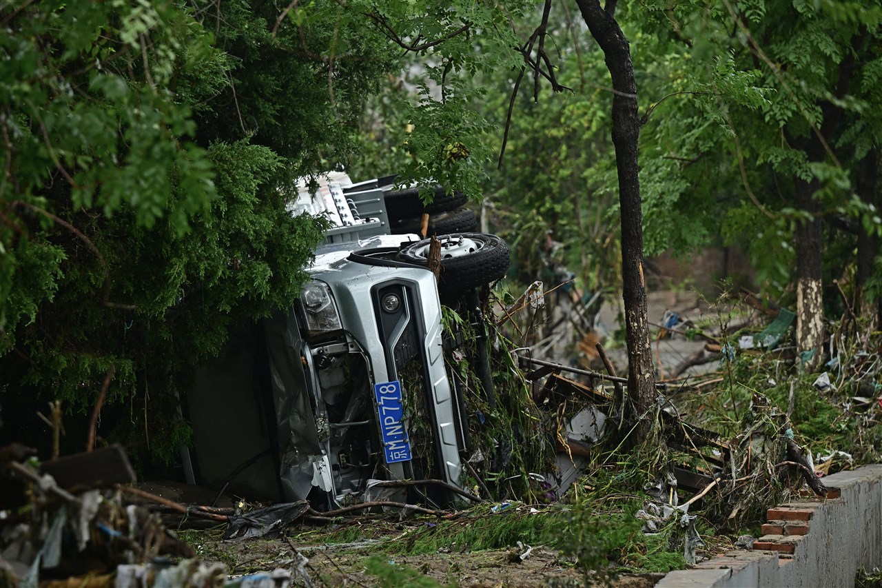 Beijing heeft te maken met ernstige overstromingen. Foto: ANP / Pedro PARDO / AFP