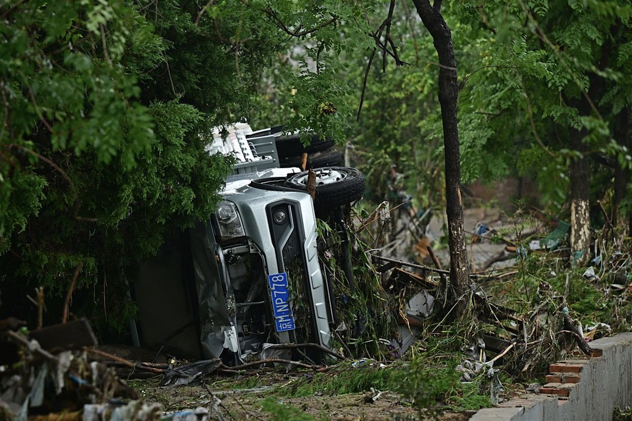 Beijing heeft te maken met ernstige overstromingen. Foto: ANP / Pedro PARDO / AFP