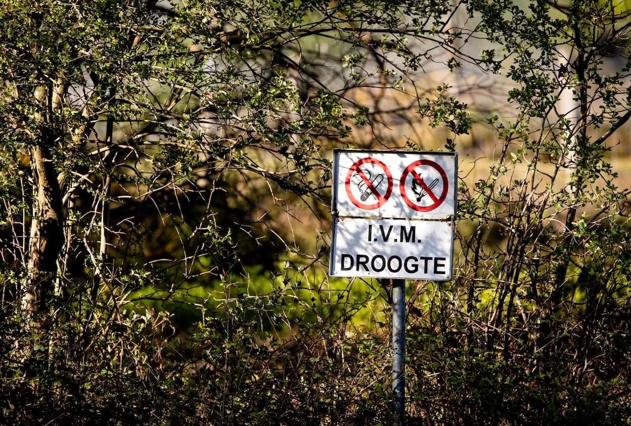 Een waarschuwingsbord voor droogte bij de ingang van het militaire oefenterrein bij het Gelderse 't Harde een dag na de uitzonderlijk grote natuurbrand. Foto: ANP / Sem van der Wal.